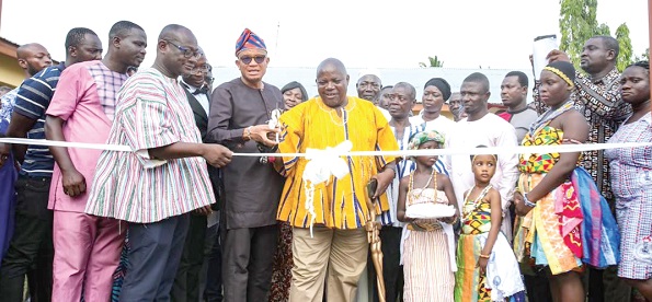  Dr Mustapha Abdul-Hamid (3rd from left) assisting Nana Kweku Dei I (4th from left), Nkosuohene of Pakro, to inaugurate one of the classroom blocks